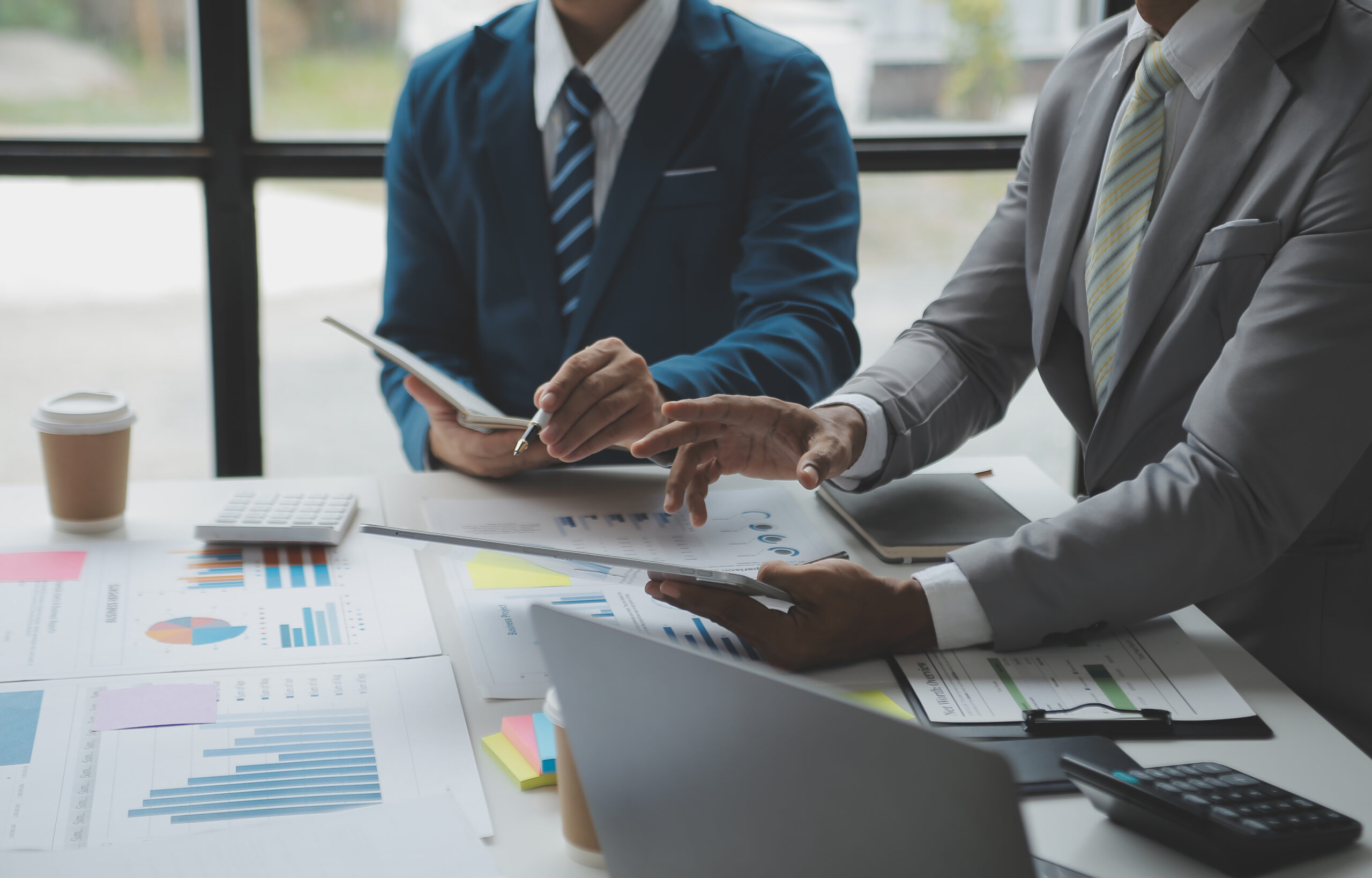 Financial analysts analyze business financial reports on a digit